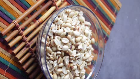 peanuts in glass bowl on mat