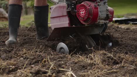 person making a hole in the ground with the blades of a machine in slow motion