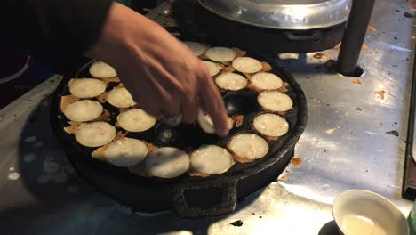 cooking concept. kind of thai sweetmeat . coconut milk mix with powder fried dessert at thai night street food market. dessert of thai traditional sweetmeat, pancake, pudding. 4k footage.