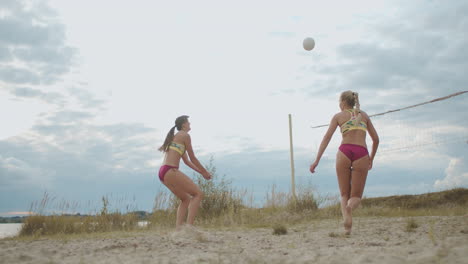 women beach volleyball match at summer day sportswomen are playing and having fun during training preparing for championship