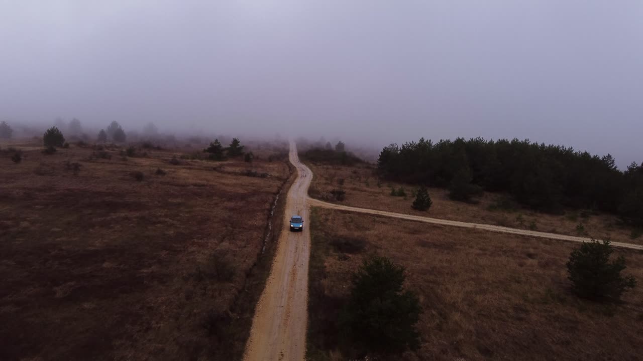 Car in the dark horror scene driving through the fog