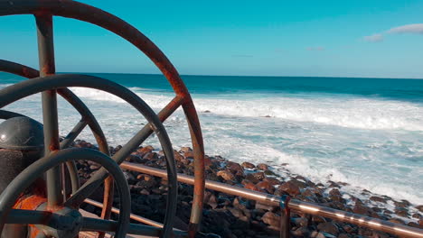 Panoramic-view-of-the-coast-of-Agaete-on-its-promenade-where-the-waves-break-with-the-coast