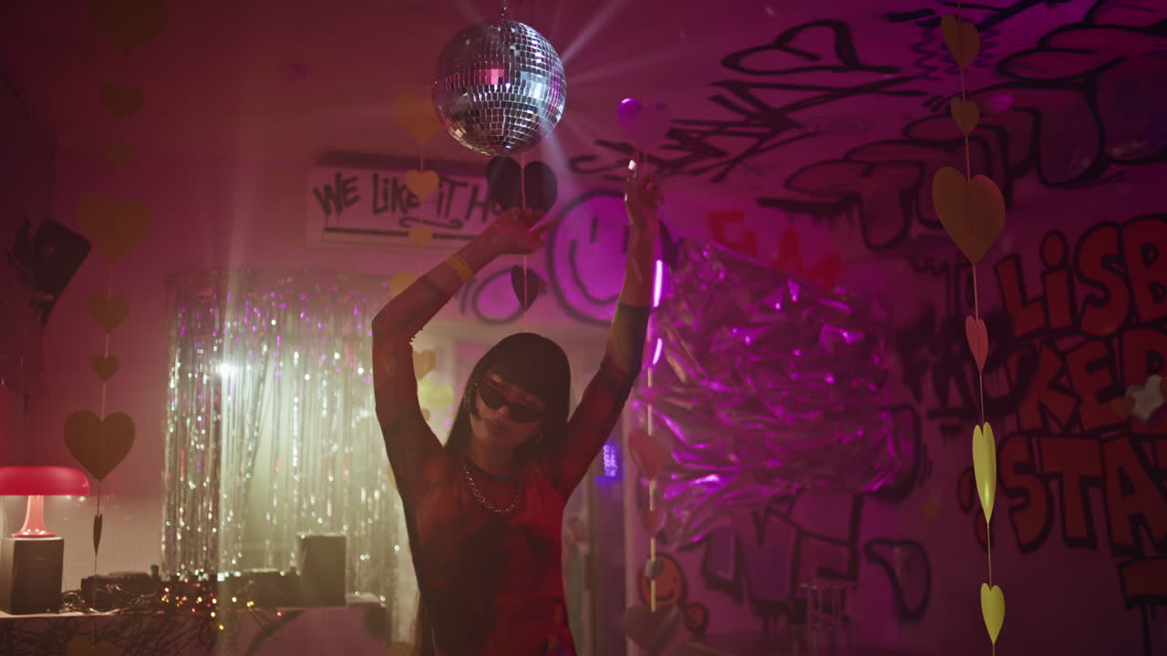 Playful girl moving disco ball nightclub closeup. fashionista dancing club