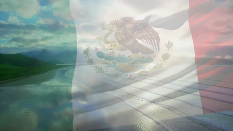 digital composition of waving mexico flag against aerial view of the beach and sea waves