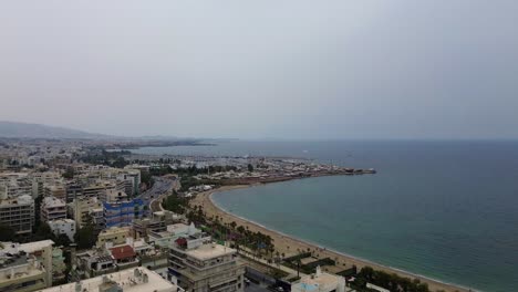 Beach-Piraeus-near-Athens,-Greece-at-Aegean-Sea-coastline,-aerial-harbour-marina