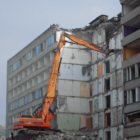 destroying old house with machine. demolition of the old industrial building