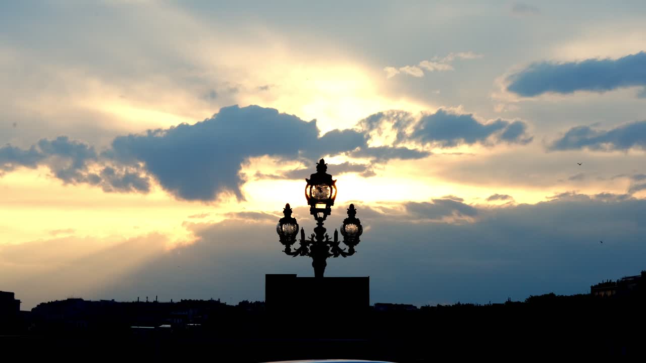 Wide and Cinematic view of the Pont Alexandre III bridge street lamps during spring sunset in Paris