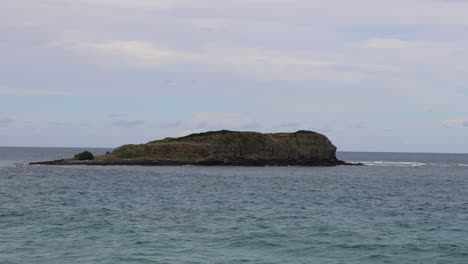 a solitary island amidst tranquil ocean waves