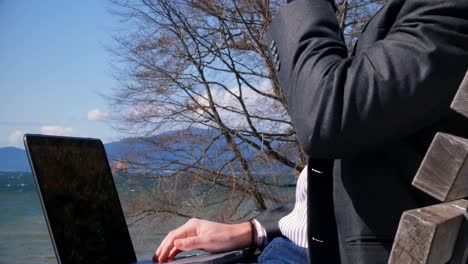 businessman using laptop in the park 4k