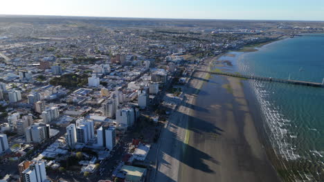 aerial cityscape of puerto madryn, the beach and the pier.