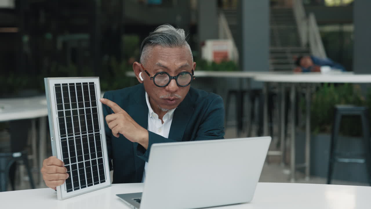 Man presenting a solar panel during a video call