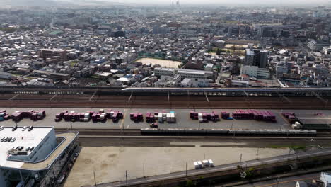 shinkansen train arriving to kyoto station in japan - aerial shot