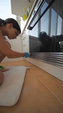 woman cleaning kitchen oven