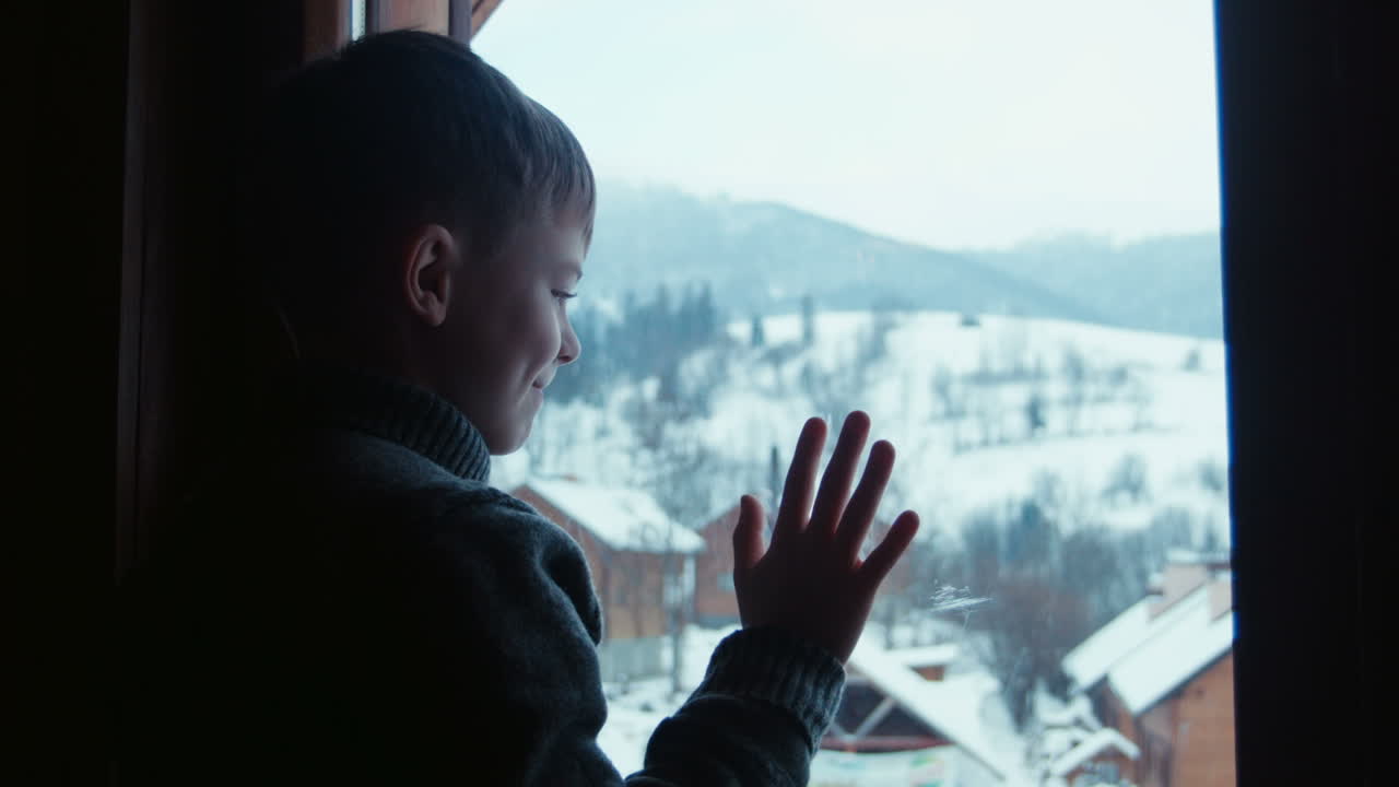 Silhouette Of Smiling Boy Draws On Window (Stock Footage)