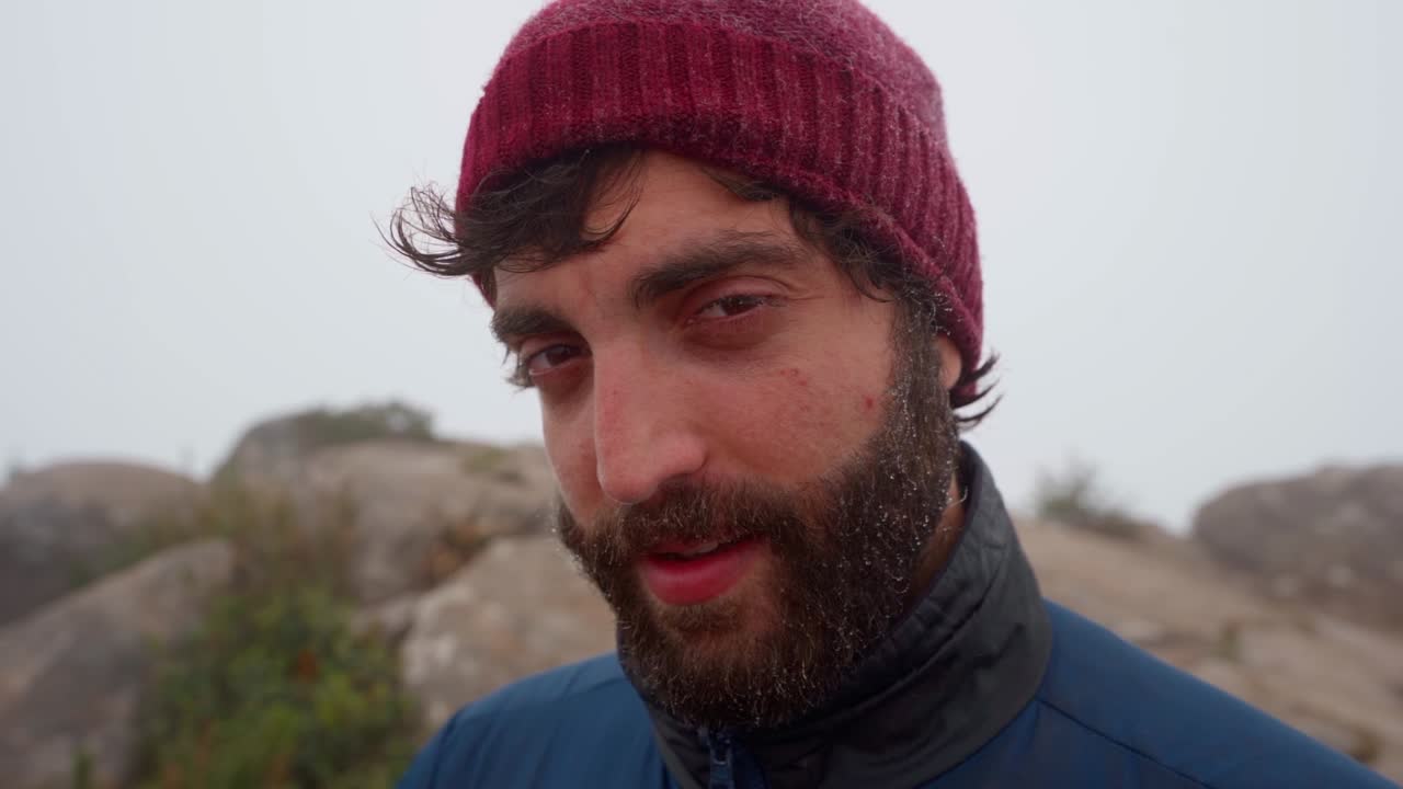Man with beanie in misty mountains, rugged mood, cold weather in Mantiqueira, Brazil