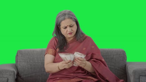 Indian-old-woman-counting-money-Green-screen