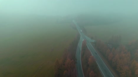 aerial view of a road in the middle of meadow