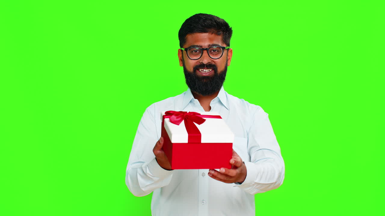 Indian man smiling offering gift birthday box kind gesture showing surprise happy giving present