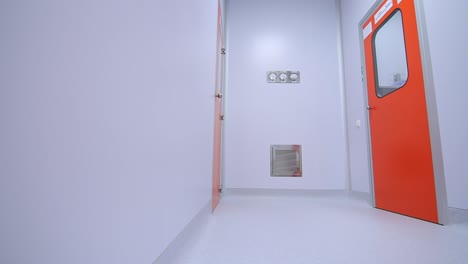 female scientist going out of laboratory room. woman researcher move in corridor