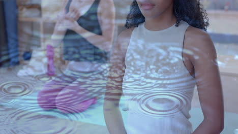 animation of ripples in water over happy diverse teenage girls practicing yoga meditation