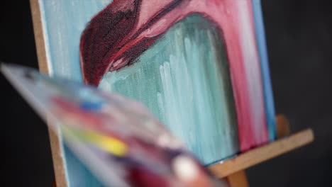closeup of an artist painting on canvas