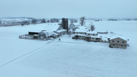 american farm covered in blanket of white snow during winter