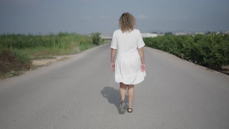 woman walking on country road