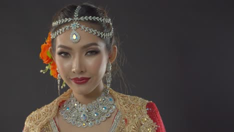 stunning indian bride in traditional dress smiles and poses for her fashion wedding portrait