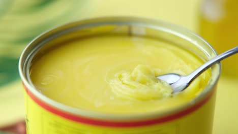 ghee in a can with spoon