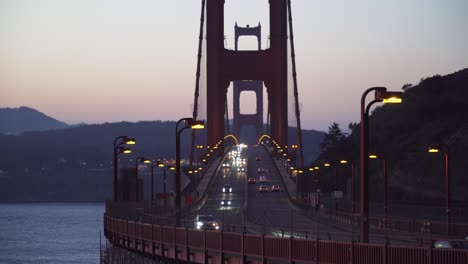 straight on shot of cars driving over golden gate bridges early morning