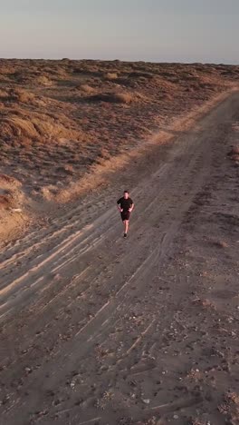 young man running in the desert landscape