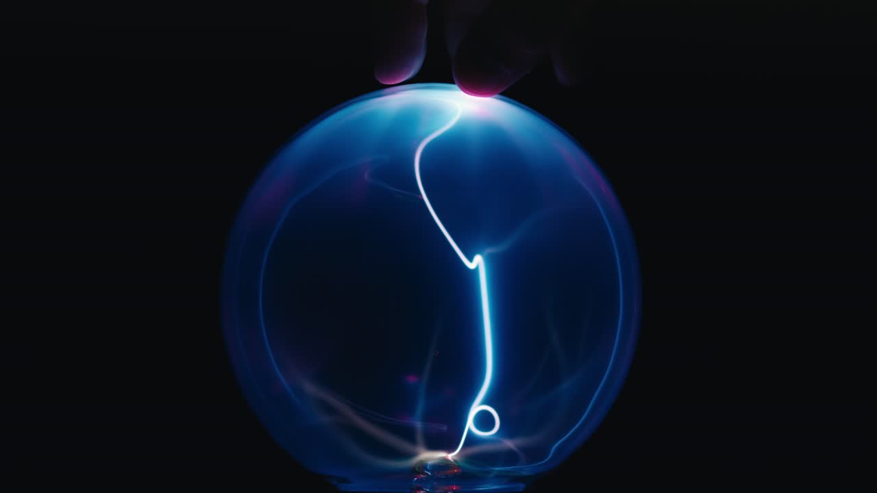 Touching Plasma Ball on black background