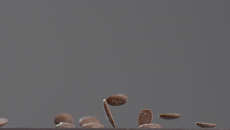 close up shot of chocolate buttons falling down