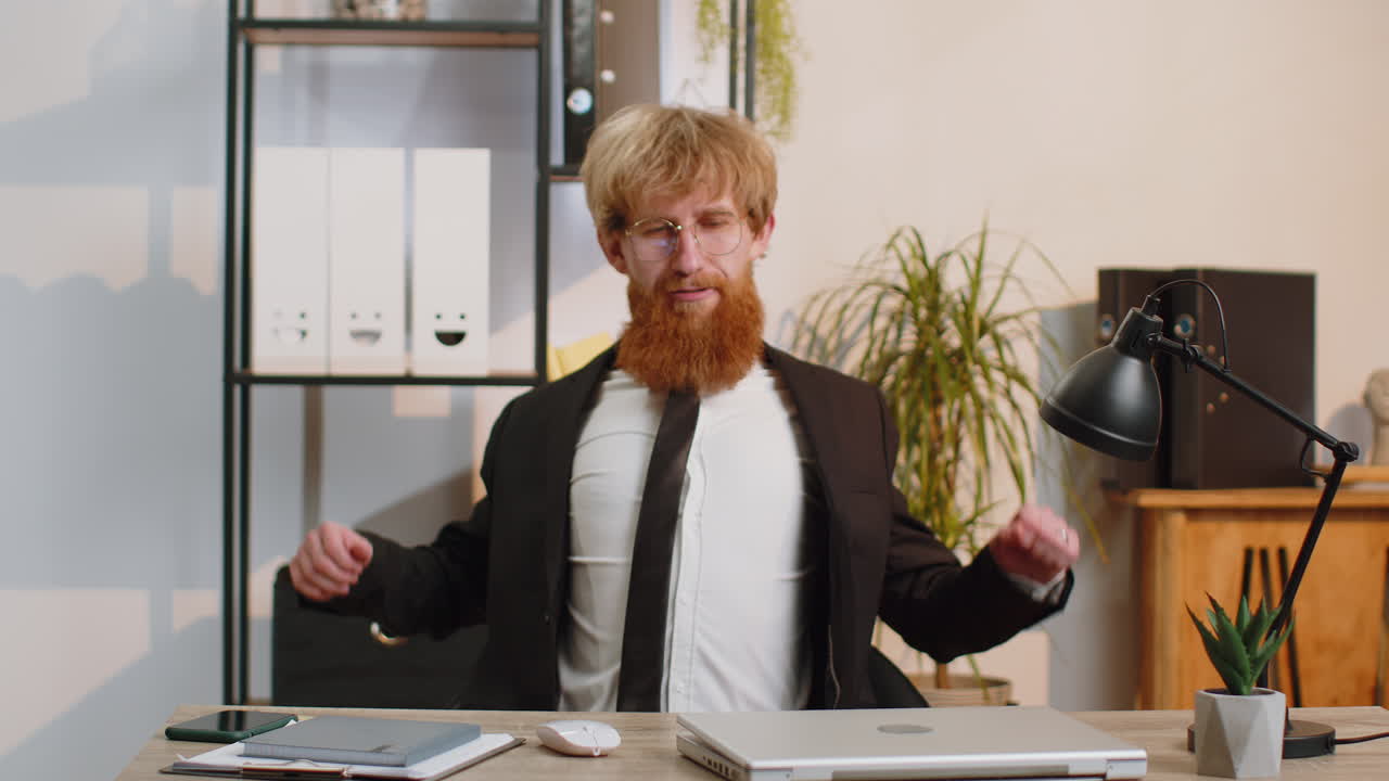 Young business man freelancer at office start working on laptop computer sends online messages