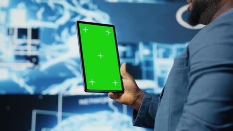 african american expert holds tablet with isolated screen next to systems