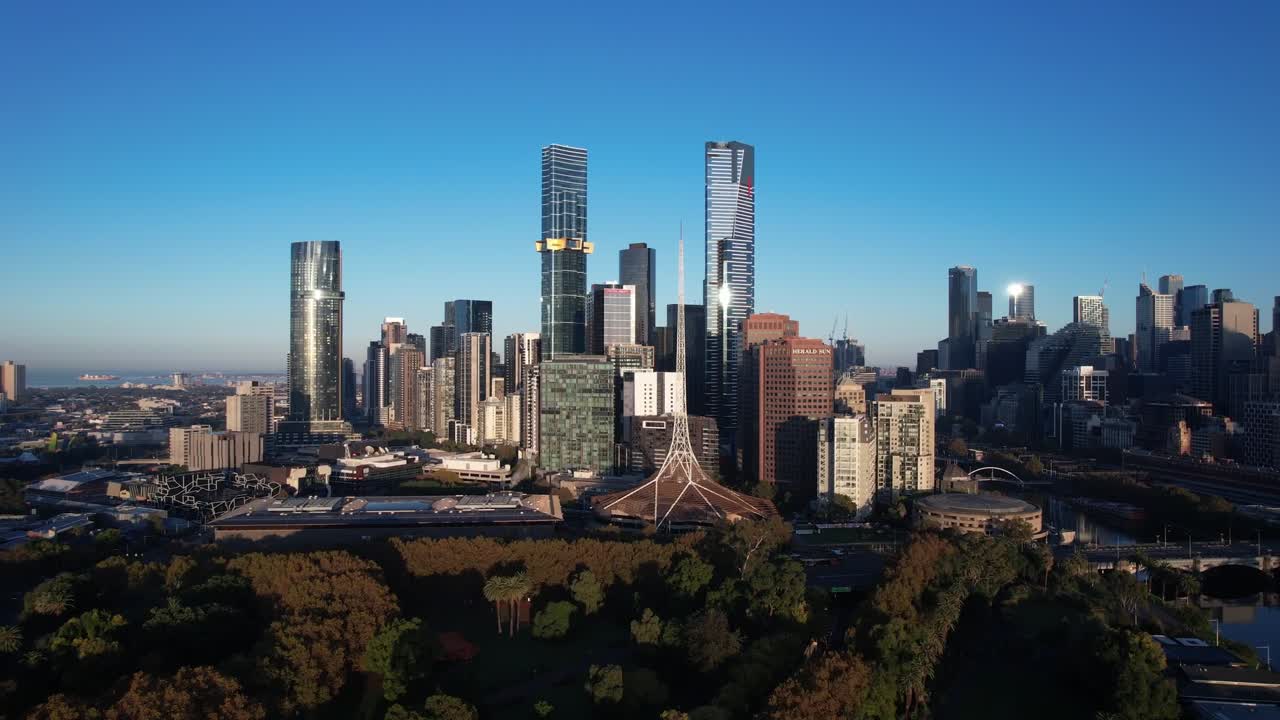 Modern skyscrapers in Melbourne financial district, drone forward on blue sky
