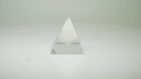 A-Beautiful-Clear,-Transparent-Crystal-Pyramid-On-Pure-White-Background---Close-Up-Shot