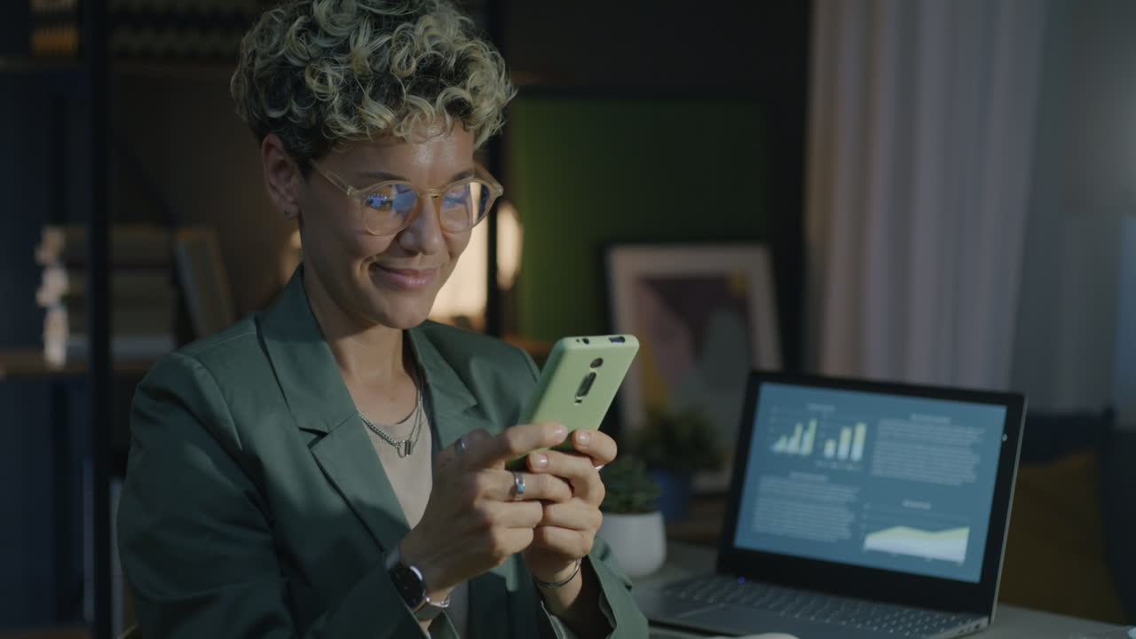 Woman Working on Smartphone at Night