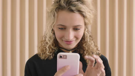 slow motion portrait of cute young blonde woman smiling enjoying texting browsing using smartphone social media technology