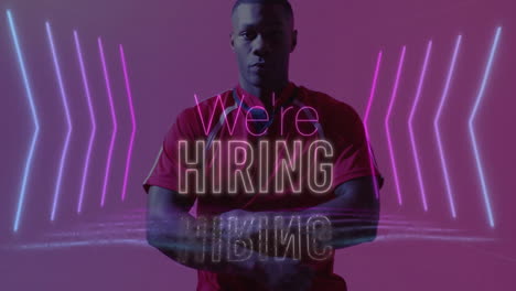In animation, man wearing red shirt with We're Hiring and pink neon lights