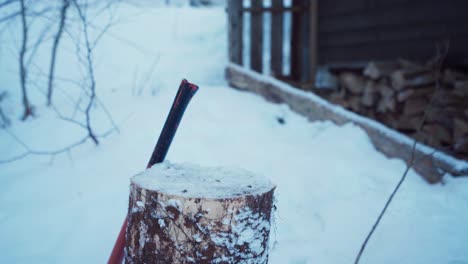 Wood-Tree-Stump-With-Person-Cutting-Timber-Log-During-Winter