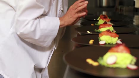 female chef finalizing dishes