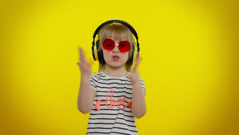 Young-blonde-teen-kid-child-girl-listening-music-via-headphones,-dancing-disco-fooling,-having-fun