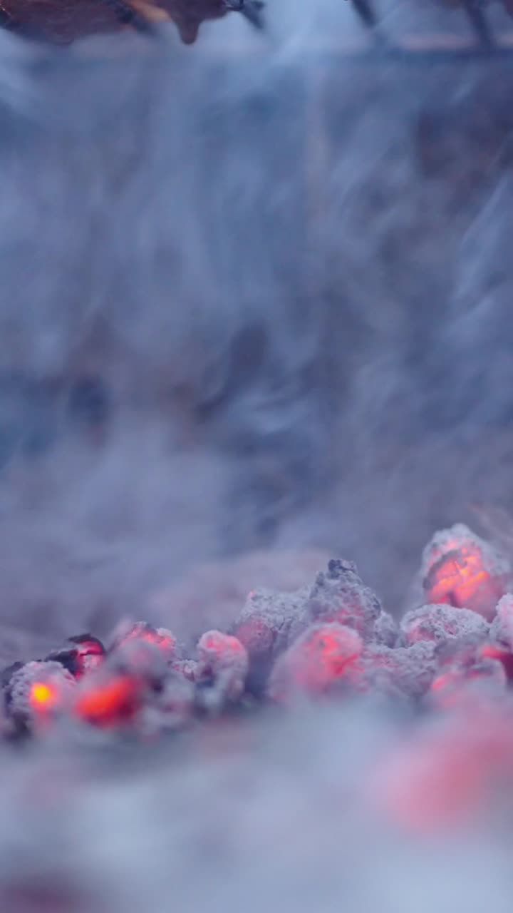 Glowing Coals with Rising Smoke