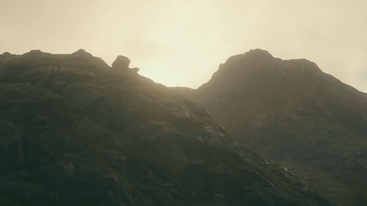 Aerial rotation through foggy morning light around Snowdonia Mountain, Snowdonia, Wales, UK.