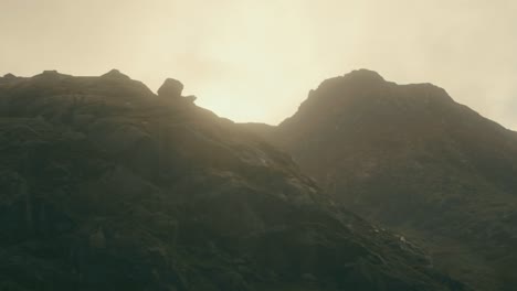 aerial rotation through foggy morning light around snowdonia mountain, snowdonia, wales, uk.