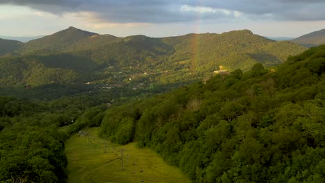 picturesque aerial flight of rainbow in appalachian mountains at sunset