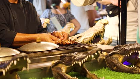 grilling crocodile meat at ao nang market