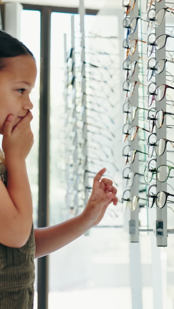 Child choosing eyeglasses at an optician