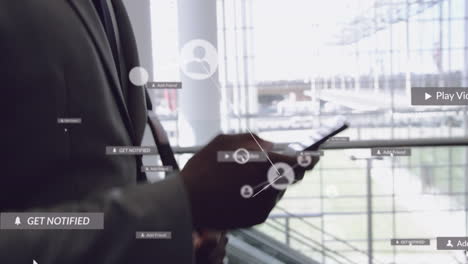 animation of network of connections with media icons over african american man using smartphone